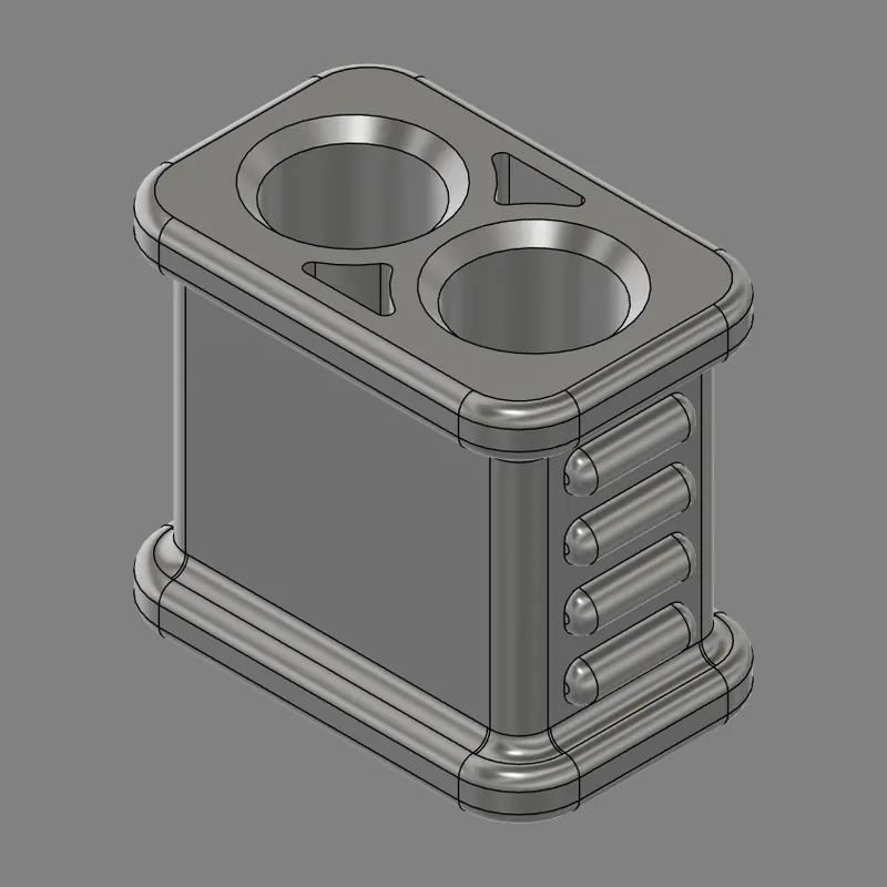 CAD model of a Moonchucks design: a rounded rectangular block with two round holes and two triangular openings in the top, and four ridges down one side.