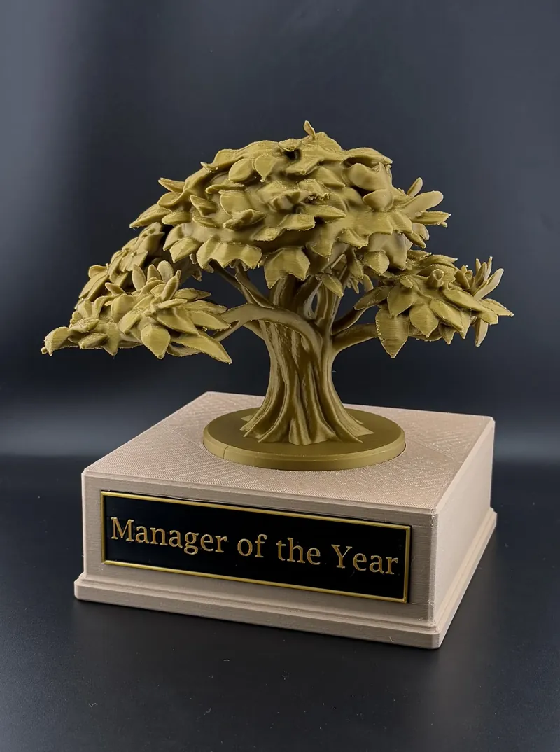 3D printed 'Manager of the Year' award: a detailed gold bonsai-style tree on a tan base with an engraved nameplate.